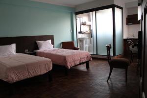 Postel nebo postele na pokoji v ubytování Kunan Hotel