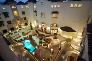 an aerial view of a building with a swimming pool at Al Rawasi Hotel Suites in Jeddah