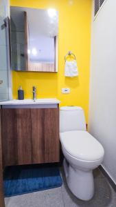a bathroom with a white toilet and a sink at Ulivin Coliving in Manizales +109 photos