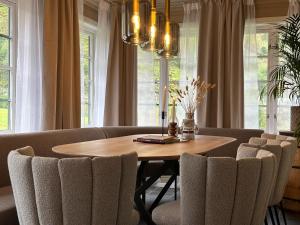 a dining room with a wooden table and chairs at Huset Vårt - Bed and Breakfast in Hornindal