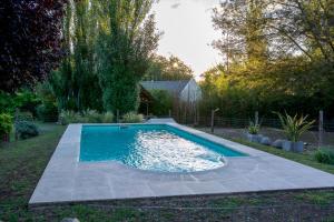 a swimming pool in a yard with a yard at Finca El Amparo in Los Reartes