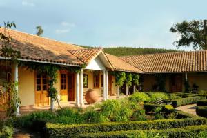 a house with a garden in front of it at La Casona At Matetic Vineyards in Lagunillas