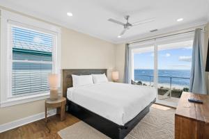a bedroom with a bed and a view of the ocean at Pet Friendly Beach House - Starfish by Panhandle Getaways in Indian Pass +57 photos