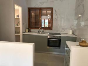 a kitchen with a sink and a stove at House Katy in Peračko Blato +22 photos