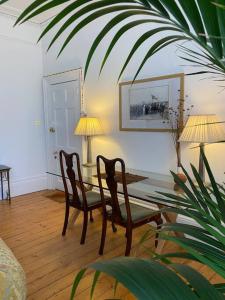 a living room with a table and two chairs at The Georgian Apartment in Worthing