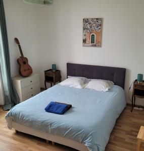 a bedroom with a bed with a blue towel on it at Petite maison proche mer - Flamanville in Flamanville