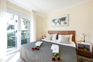 a bedroom with a large bed with two towels on it at Villa Goga Exclusive Escape in Novalja +14 photos