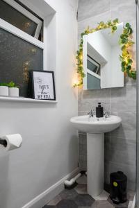 a bathroom with a sink and a mirror at The Cave in Coventry