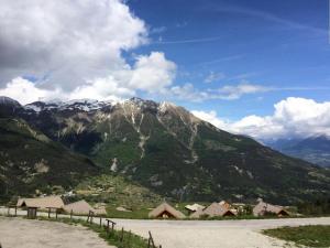 Blick auf einen Berg mit Häusern und einer Straße in der Unterkunft Résidence Gardette - Superbe vue sur les montagnes de ce T2 à Réallon A13 MAE-9051 in Réallon