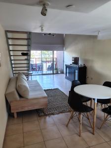 a living room with a couch and a table at Mono en Duplex Velez Sarsfield 2 in Buenos Aires +24 photos