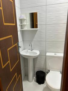 a bathroom with a sink and a toilet at Residencial Angelina in Praia do Forte +61 photos