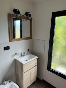 a bathroom with a sink and a mirror at Patagonia Hope Suites in El Calafate +29 photos