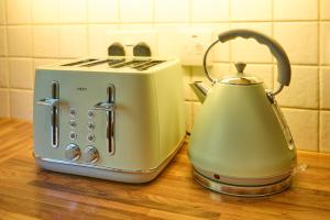 a toaster sitting on top of a wooden counter at Charming 2BD House - Parking & Garden in Oban in Oban