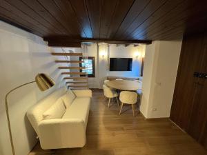 a living room with a couch and a table at Splendida Baita nel verde in Courmayeur