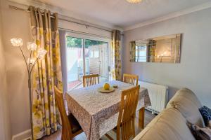 a dining room with a table and chairs and a window at Charming 2BD House - Parking & Garden in Oban in Oban