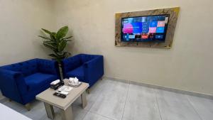 a living room with a blue couch and a table at Royal palace hotel in Lahore