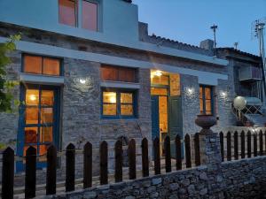 a house with a fence in front of it at Casa Petrino in Samos