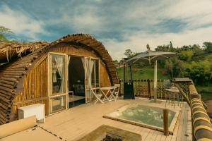 a small house with a hot tub on a deck at Atma Villas Hotel Boutique Guatapé in Guatapé