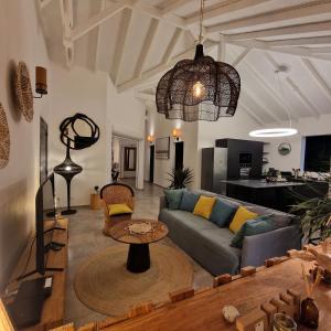 a living room with a couch and a table at Villa MiLouMa in Saint-François