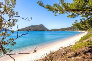 a view of a beach with a mountain in the background at Lorikeet Retreat 2 Pet Friendly Air Conditioned Holiday House in Shoal Bay