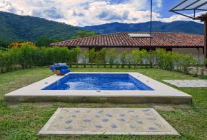 a swimming pool in the yard of a house at Hacienda La Tulia Eco Hotel in Toro