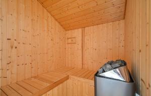 a wooden sauna with a trash can in it at Three-Bedroom Holiday Home In Ebeltoft in Ebeltoft