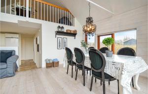 a dining room with a table and chairs at Three-Bedroom Holiday Home In Ebeltoft in Ebeltoft