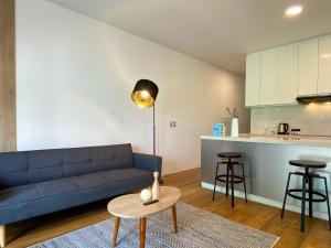 a living room with a blue couch and a table at Duplex with Balcony in Barranco in Lima +6 photos