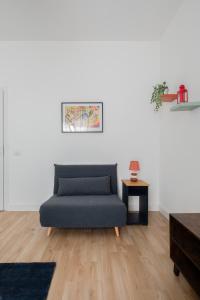 a living room with a blue couch and a table at Dimora al belvedere in Frascati