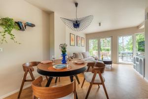 a living room with a dining room table and chairs at Leśny Duet 2 in Huta Podgórna