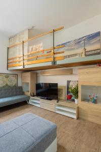 a living room with a bunk bed and a couch at L'originario Salviano Family Apartment in Livorno