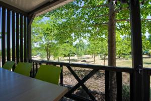 a screened porch with a table and chairs and a tree at Camping Karin in Gornji Karin