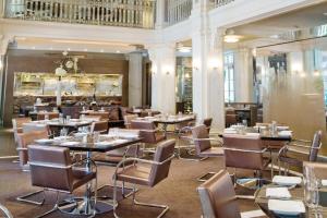a restaurant with tables and chairs and a bar at The Georgian Terrace Hotel in Atlanta
