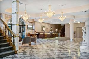 a lobby with a staircase and chandeliers at Chateau Big Bear Boutique Hotel, BW Signature Collection in Big Bear Lake +43 photos