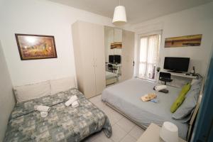 a bedroom with a bed and a desk and a television at Camyhouse in Turin
