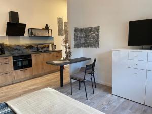 a kitchen with a table and a tv and a counter at Nordwind in Osterholz-Scharmbeck