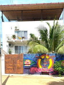 a fence with a colorful mural in front of a building at Casa De La Palmera in Brisas de Zicatela