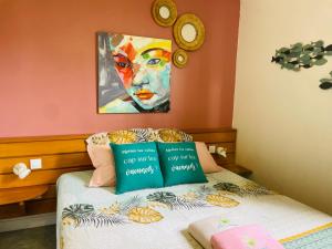 a bedroom with a bed with a painting on the wall at Le Catelya - Résidence Manganao in Saint-François +39 photos