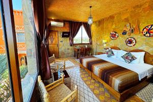 a bedroom with a bed in a stone room at Riad Chay & Boutique in Ouarzazate