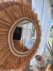 a large circular mirror in a room with a chair at Love Room Les sens'même in Bouloupari