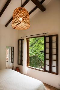a bedroom with a bed and a large window at Casa Da Ro in Ilhabela