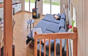 a living room with a blue couch and a fireplace at Ferienhaus Wandlitz in Berg