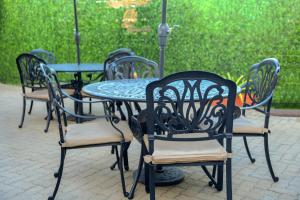 a group of chairs and a table in a patio at Q's Boutique Stay in Standerton