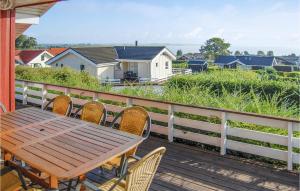 a wooden table and chairs on the balcony of a house at Holiday Home Hvedemarken Sjølund Iii in Hejls
