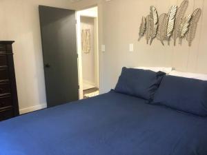 a bedroom with a blue bed with blue sheets at Walnut River's Edge Guesthouse in El Dorado