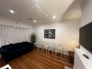 a living room with a black couch and chairs at Ocean Eyre in Cowell