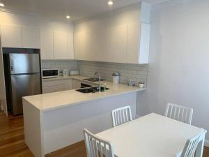 a kitchen with a counter and a sink and a refrigerator at Ocean Eyre in Cowell