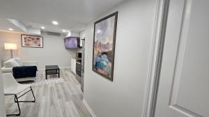 a living room with a painting on the wall at Garden Ave Home 1mins to HWY 403 in Brantford