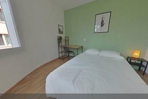 a white bedroom with a large bed and a table at 3 bedrooms-Very bright and spacious appt- wifi in Toulon +1 photo
