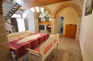 a dining room with a table and chairs and a kitchen at Holiday Home Svalba in Rovinj
